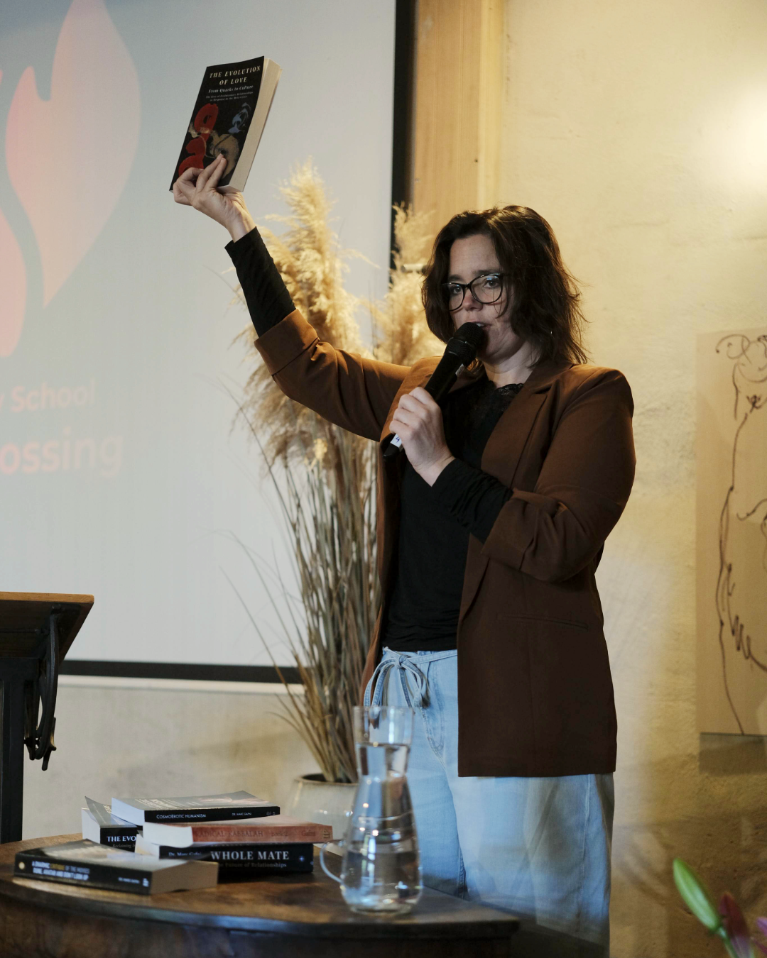 Dr. Kristina Kincaid holding up The Evolution of Love